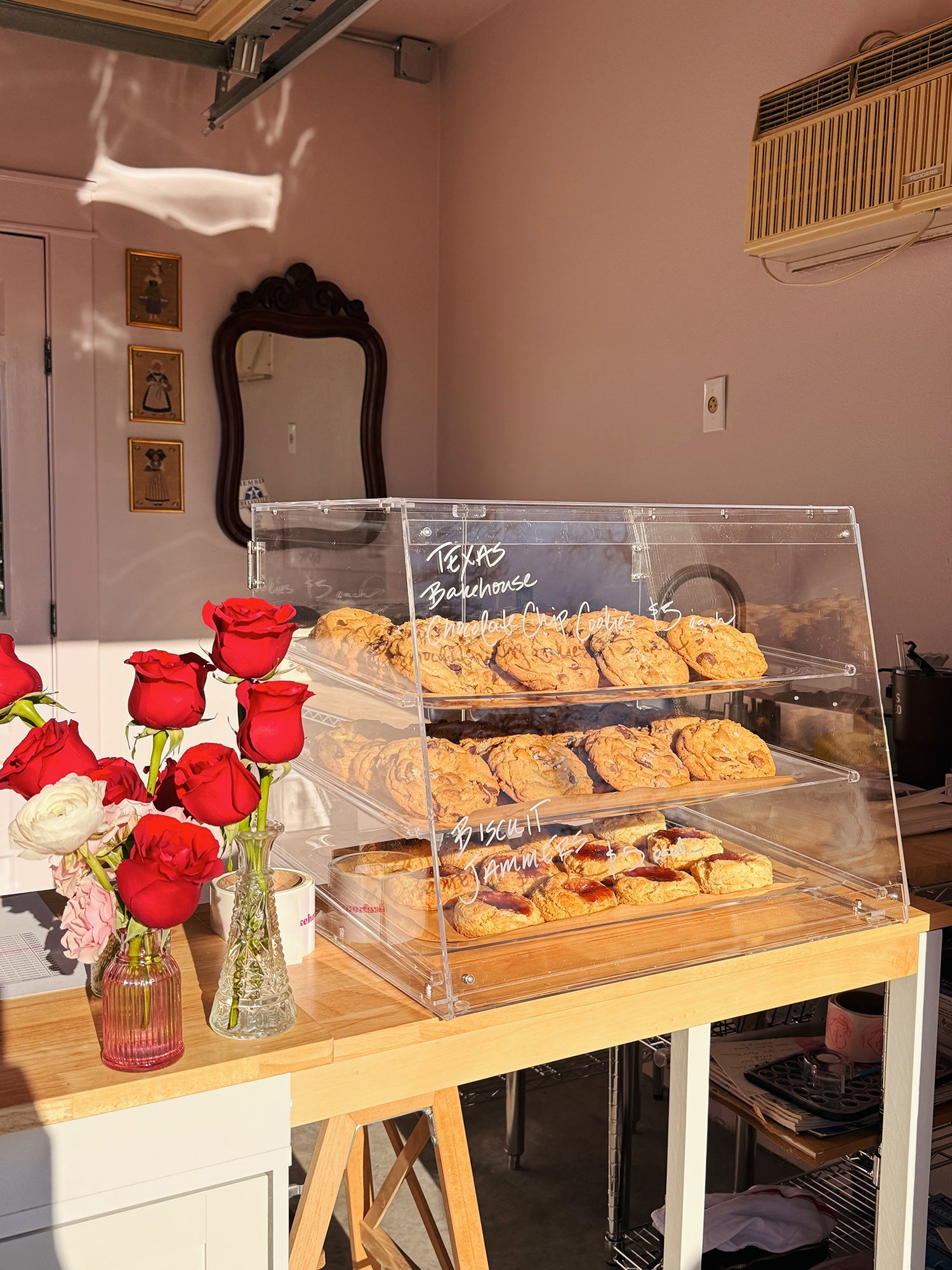 Display case filled with Texas Bakehouse Chocolate Chip Cookies and Biscuit Jammers